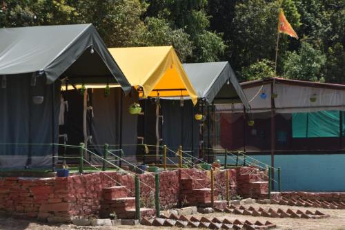 a group of tents in a yard with bricks at Moonlight Camp Dhanachuli Mukteshwar in Nainital