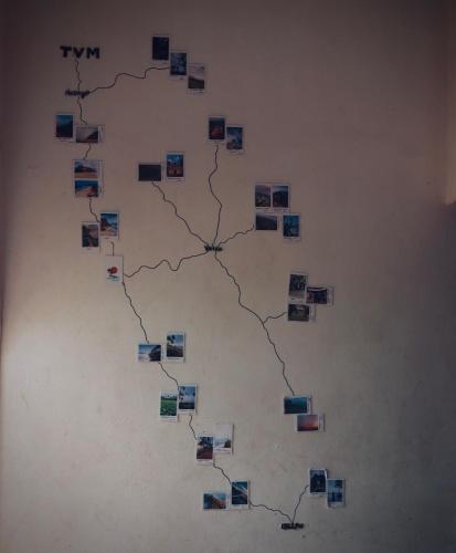 a wall with many pictures on it at Paradise Inn Beach Resort in Varkala