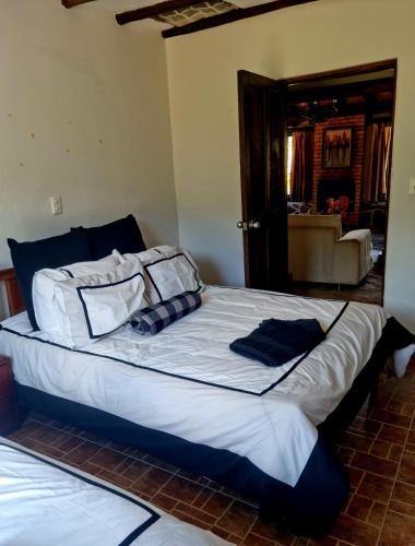 a large bed with pillows on it in a bedroom at La Casona Cucaita. Sede Campestre in Cucaita