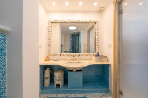 a bathroom with a sink and a mirror at Relais Bijoux Ischia in Ischia