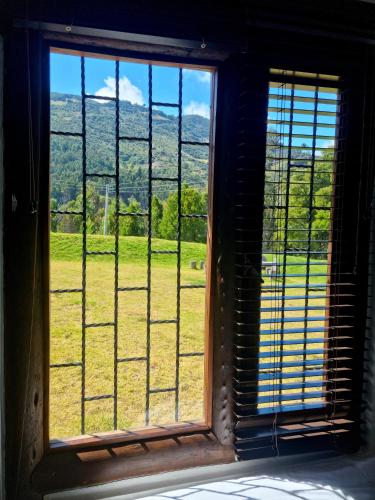 an open window with a view of a field at La Casona Cucaita. Sede Campestre in Cucaita
