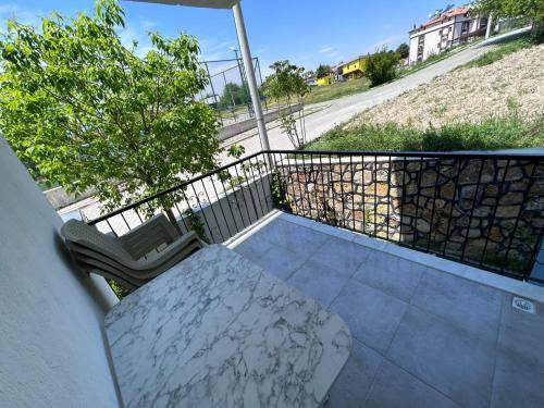 a table and two chairs on a balcony with a fence at Paradise House in Pamukkale