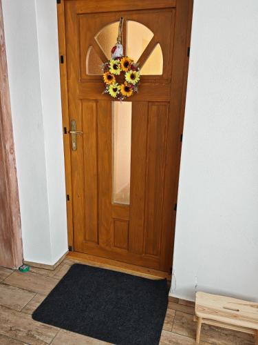 a wooden door with a wreath on it at Ondrašovská skala in Ondrašová