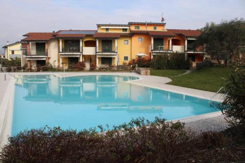 a large swimming pool in front of a building at New Home Lazise in Lazise