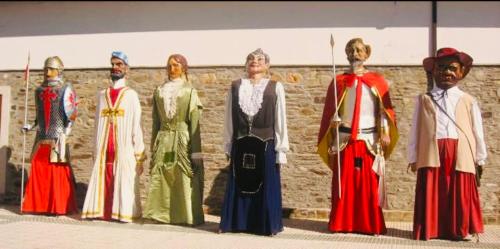 a group of mannequins dressed in costumes in front of a wall at Hotel & Restaurante El Casino in Villafranca del Bierzo