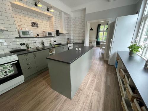 a large kitchen with a large island in the middle at Alingsås Vandrarhem in Alingsås