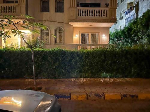 a car parked in front of a building at night at 6th Of October Signature Stay in 6th Of October