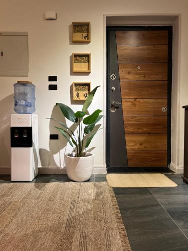 a hallway with a door and a potted plant at 6th Of October Signature Stay in 6th Of October