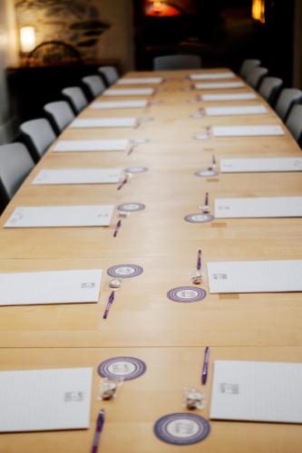 a long wooden table with glasses on it at Lancaster Arts Hotel in Lancaster