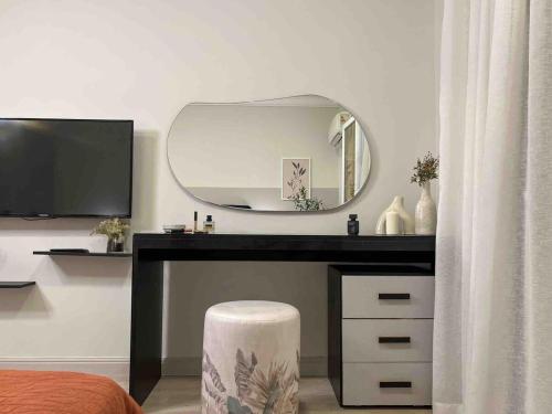 a bedroom with a desk with a large mirror at 6th Of October Signature Stay in 6th Of October