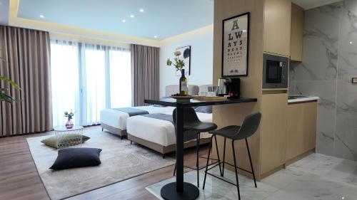 a bedroom with a bed and a table and chairs at CC LUX Suites in Piraeus