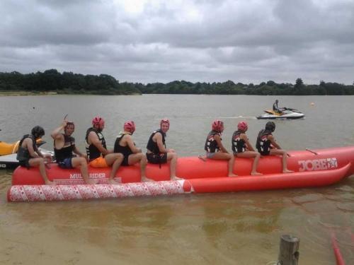 a group of people sitting on a red raft in the water at Camping 4 étoiles - Piscine - ccb0bif in Apremont