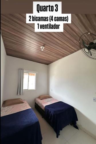 Ένα ή περισσότερα κρεβάτια σε δωμάτιο στο Casa de praia com Piscina