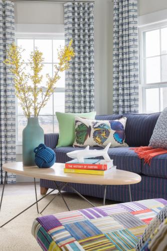 a living room with a blue couch and a table at Summercamp in Oak Bluffs