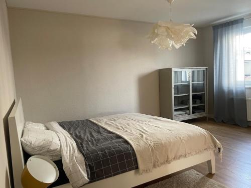 a bedroom with a bed and a chandelier at 70 qm Wohnung in Neuwied