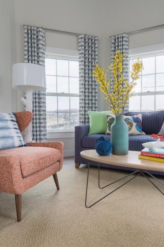 a living room with a couch and a table with a vase at Summercamp in Oak Bluffs