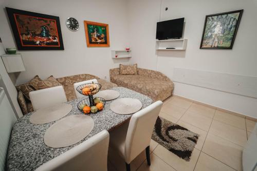 a living room with a table and a couch at B&B Passage in Sremska Mitrovica