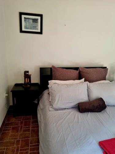 a bed with white sheets and pillows in a bedroom at La Casona Cucaita. Sede Campestre in Cucaita