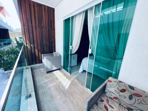 a balcony of a house with a glass wall at Star Hotel in Jericoacoara