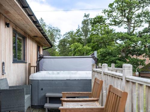 a hot tub on the deck of a house at Lodge W Hot Tub, Outdoor Dining In National Park in Otterburn