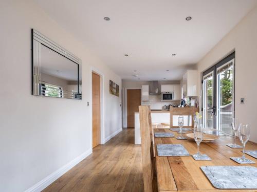 a kitchen and dining room with a table and a dining room at Lodge W Hot Tub, Outdoor Dining In National Park in Otterburn