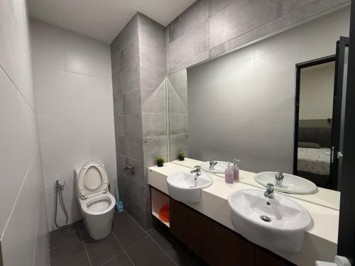 a bathroom with two sinks and a toilet at Gala City CornerApt Gala residence in Kuching