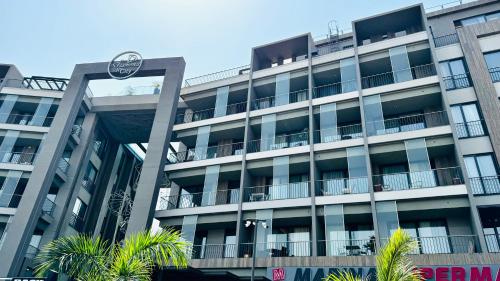 un edificio de apartamentos con un reloj a un lado en Elite Luxury Suites at Diamond in City, en Accra