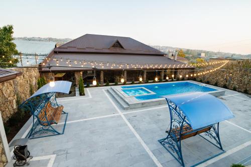 a patio with two chairs and a swimming pool at Villa Ashtarak in Ashtarak
