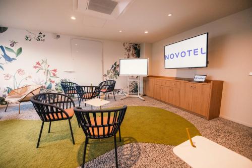 a meeting room with chairs and a projection screen at Novotel Le Havre Centre Gare in Le Havre