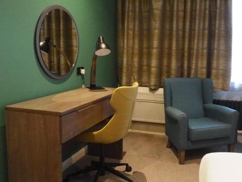 a room with a desk and a chair and a mirror at Holiday Inn Telford Ironbridge by IHG in Telford