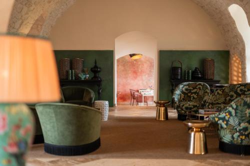 a living room with chairs and a table at Masseria Santo Scalone in Ostuni