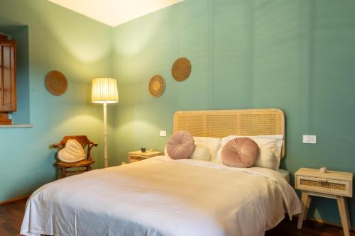 a bedroom with a bed with two pillows on it at Dimora Boccaccio by VacaVilla in Strada