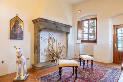 a living room with two chairs and a fireplace at Dimora Boccaccio by VacaVilla in Strada