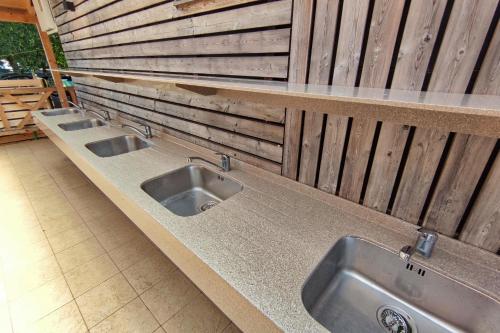 a kitchen with three sinks on a counter at Camping Bela krajina - Pitches in Gradac