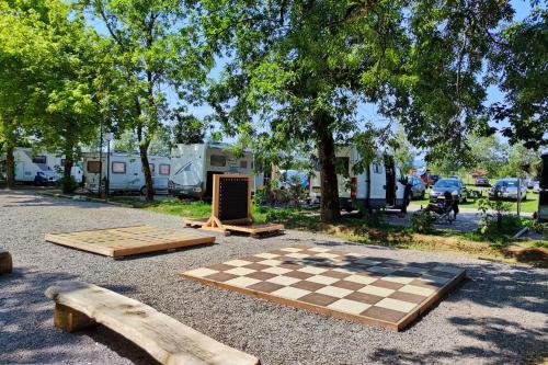 two wooden chess boards and a chessboard on the ground at Camping Bela krajina - Pitches in Gradac