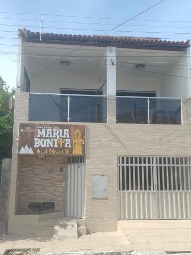 a building with a sign on the side of it at Pousada Maria Bonita in Macau