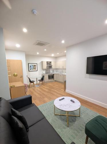 a living room with a couch and a table at House of Fisher - 100 Kings Road in Reading