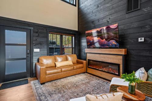 a living room with a couch and a fireplace at Sunset in the Glades in Gatlinburg
