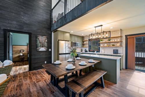 a kitchen and dining room with a wooden table and bench at Sunset in the Glades in Gatlinburg