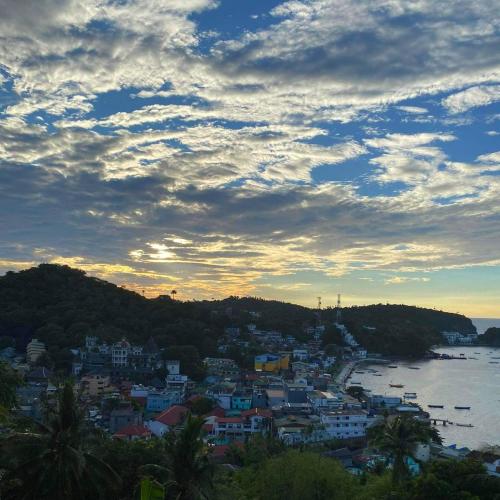 a view of a city with the ocean and buildings at Dream Hill Condos & Spa in Puerto Galera
