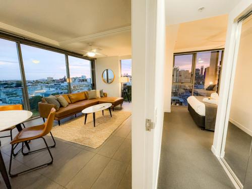 a living room with a couch and a table at Apartments on Connor in Brisbane