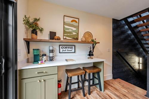 a kitchen with a counter and stools in a room at Sunset in the Glades in Gatlinburg