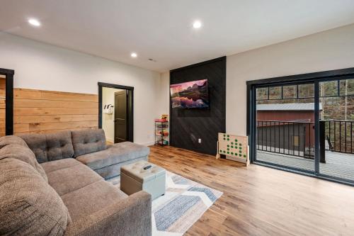 a living room with a couch and a large window at Sunset in the Glades in Gatlinburg