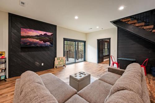 a living room with a large couch and a large wall at Sunset in the Glades in Gatlinburg