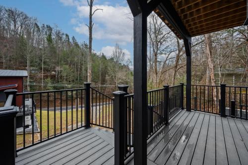 a screened in porch with a view of a pond at Sunset in the Glades in Gatlinburg