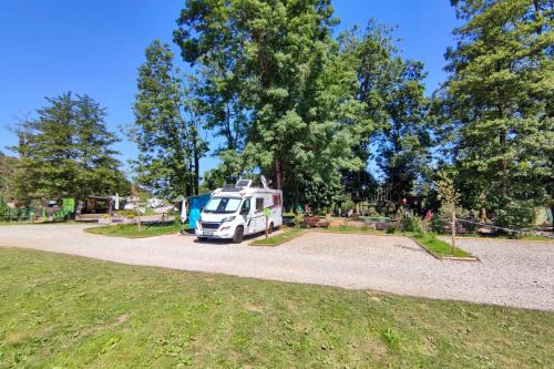 a white van parked in a parking lot at Camping Bela krajina - Pitches in Gradac