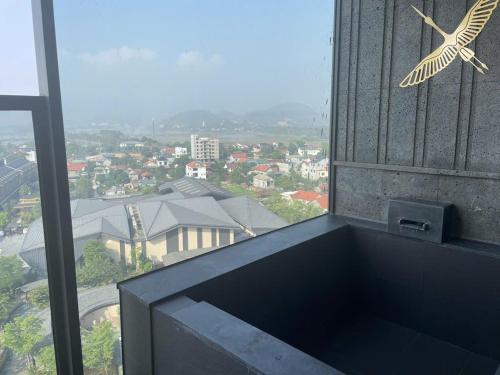 a building with a bird clock on the side of it at Lynn Times Thanh Thuỷ hotspring-KS 35 tầng- My Home in Phú Thọ