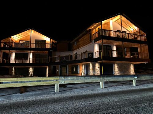 a large apartment building at night with its lights on at Arnica Alpin Lodge in Cavedago
