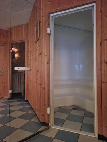 a sliding glass door in a room with a tiled floor at Pension- Appartement Kristall in Tröpolach