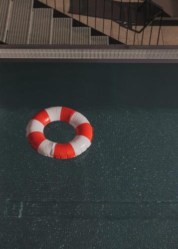 a red and white life buoy on the floor of a swimming pool at GOING TRIPLE A apartments EAST in Going